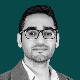 a man wearing glasses and a suit